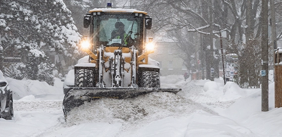 snow removal truck clearing snow from road