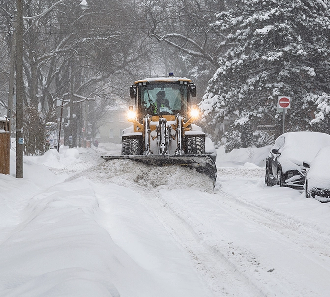 snow removal truck clearing snow from road