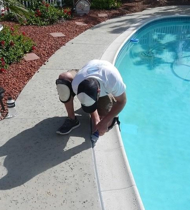 professional man repairing pool coping professional man repairing pool coping