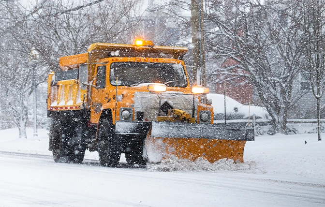 snow removal service in snow storm on road