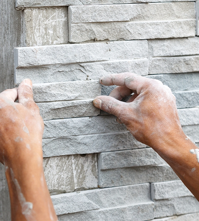 stone wall installation process man installing stone wall