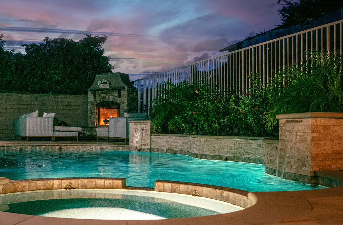 swimming pool waterfalls and hot tube in home backyard