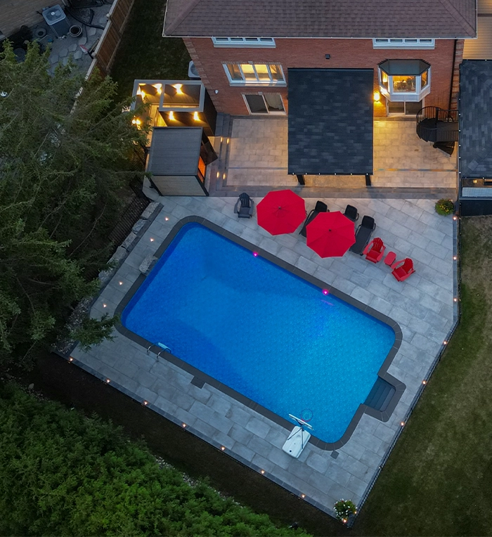 luxury backyard, interlocking surface around pool, sitting setup and cabanas