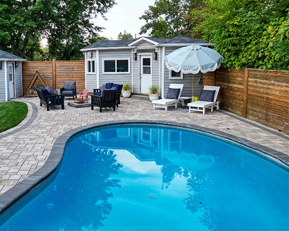 large vinyl pool with interlocking floor in home backyard