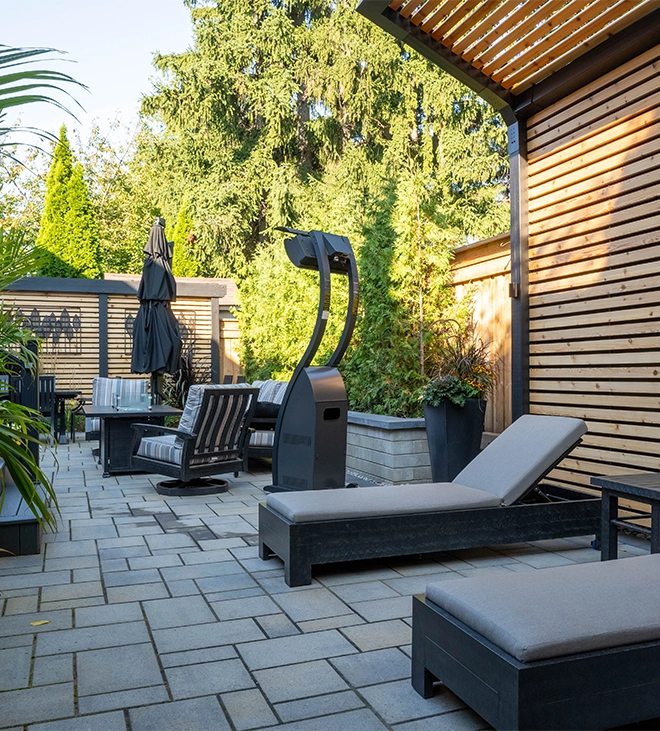 wooden fence, interlocking surface and privacy screen in backyard