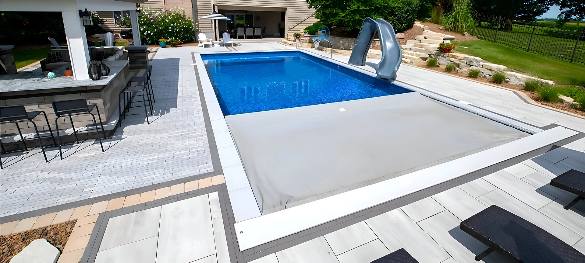 automatic large swimming pool cover in home backyard
