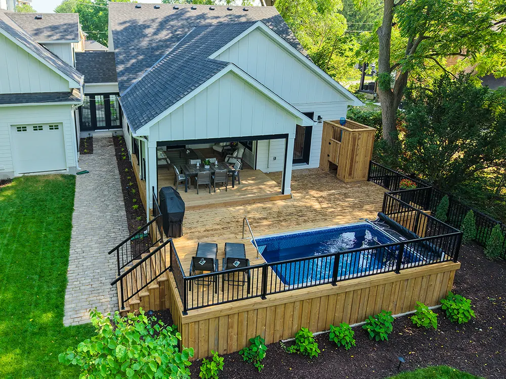 large deck with built in pool in a beautiful backyard