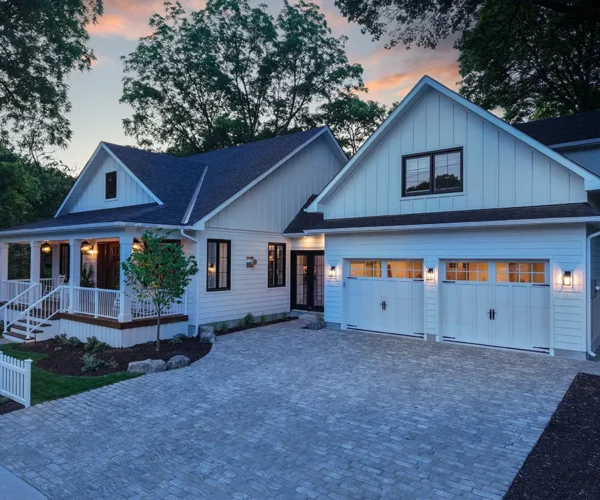 driveway-hardscaping large home with a big interlocked driveway in the evening