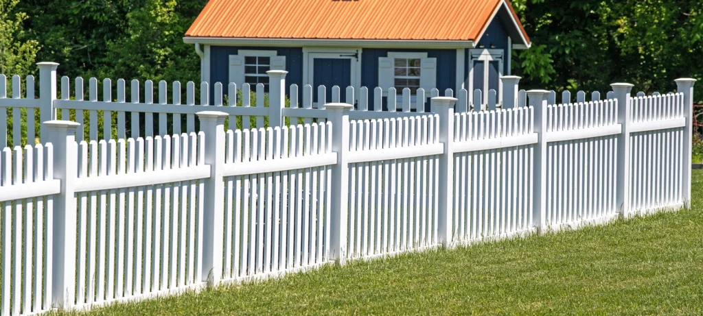 white vinyl fence fencing of private property grass plastic nature clean modern green garden