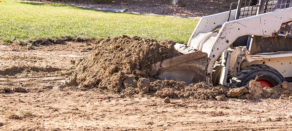 Small Bulldozer Digging In Yard For Pool Installation.
