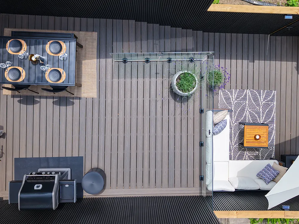 large deck with table and bbq and couches on multi levels