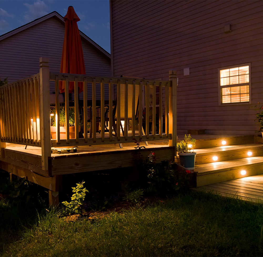 wooden deck with lighting and railing