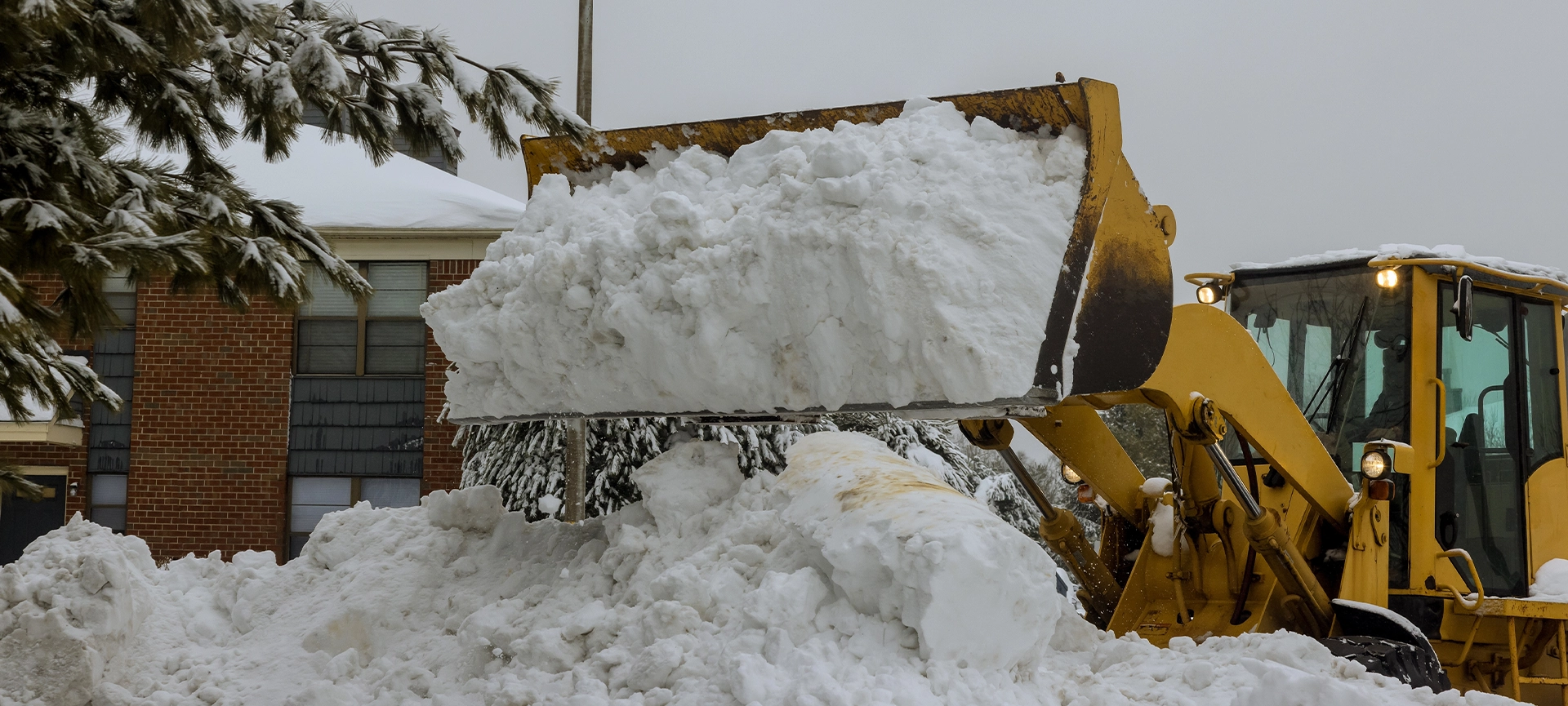 Snow removal with truck to clear parking lot and road of snow