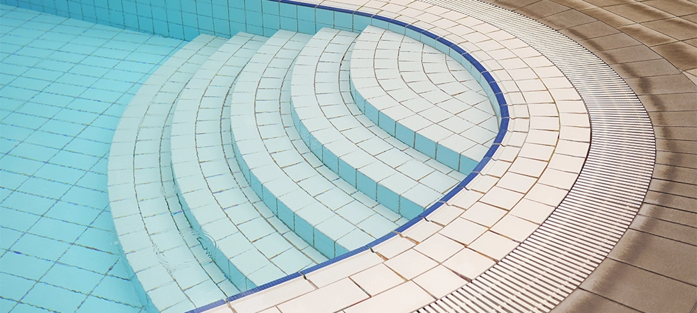 an empty swimming pool with poll stair.