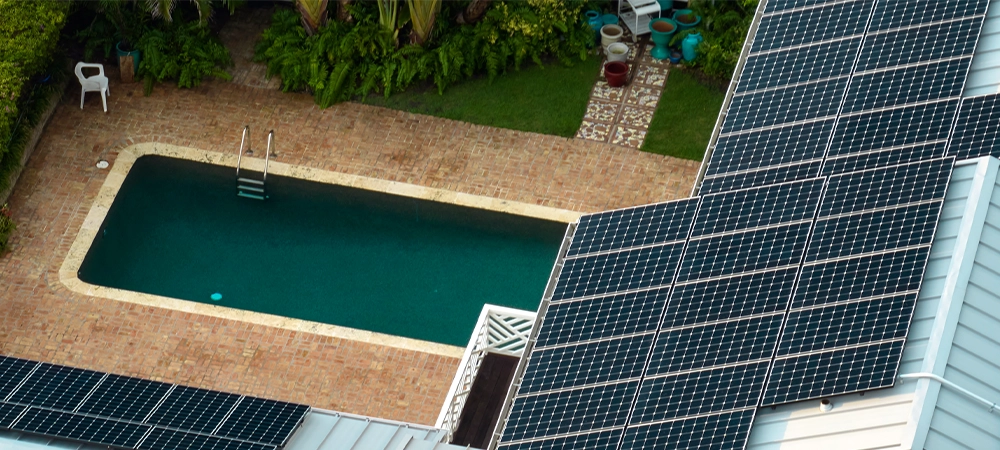 Aerial view of new expensive american home roof with blue solar photovoltaic panels