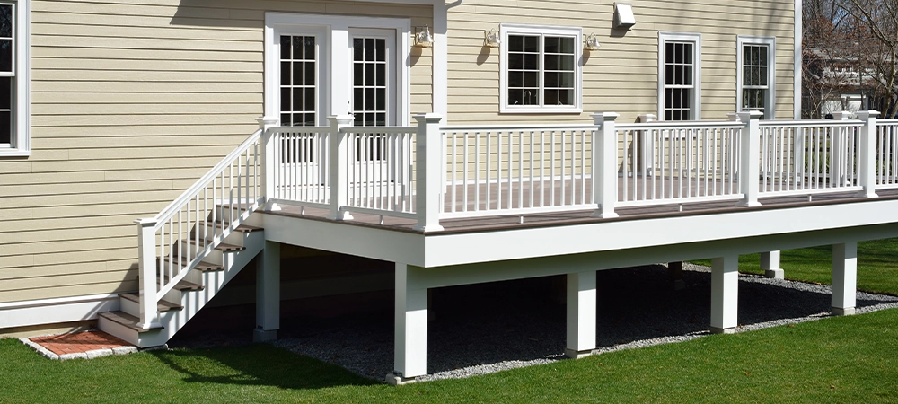 deck railing with footing and stairs toward home backyard