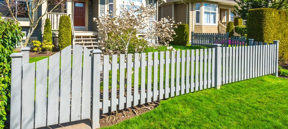long wooden fence with nicely trimmed grass.