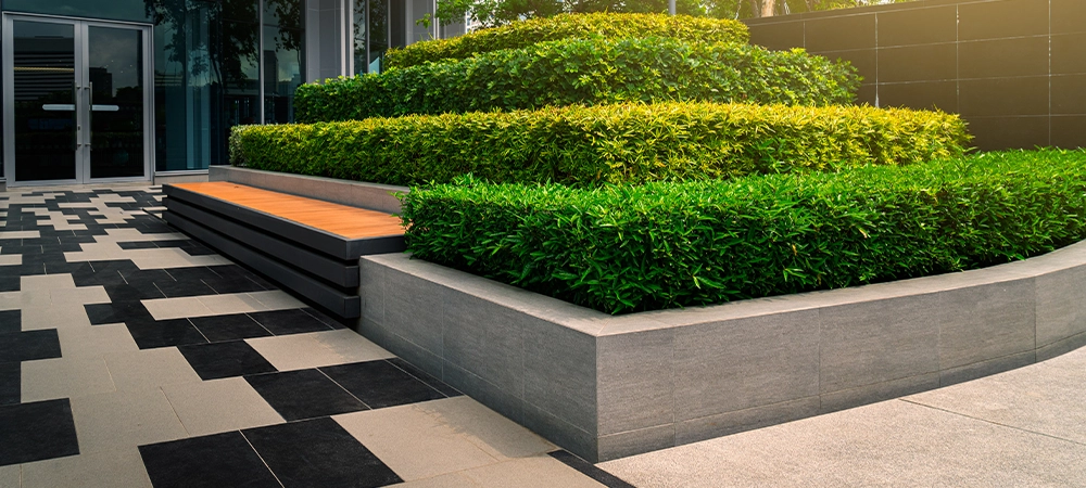 Beauiful outdoors gardening decoration with bench of an modern office building, outdoor gardening image for corporate buildings concept.
