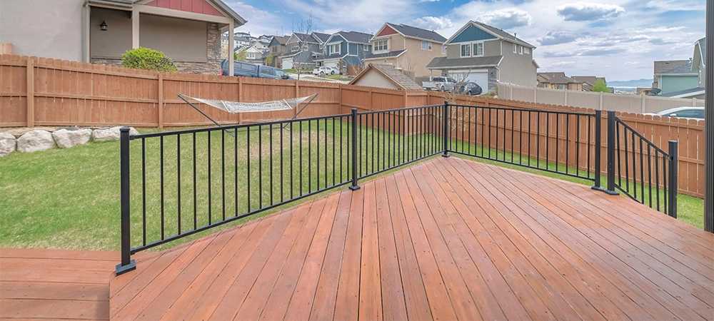 House deck with wooden flooring and metal railings