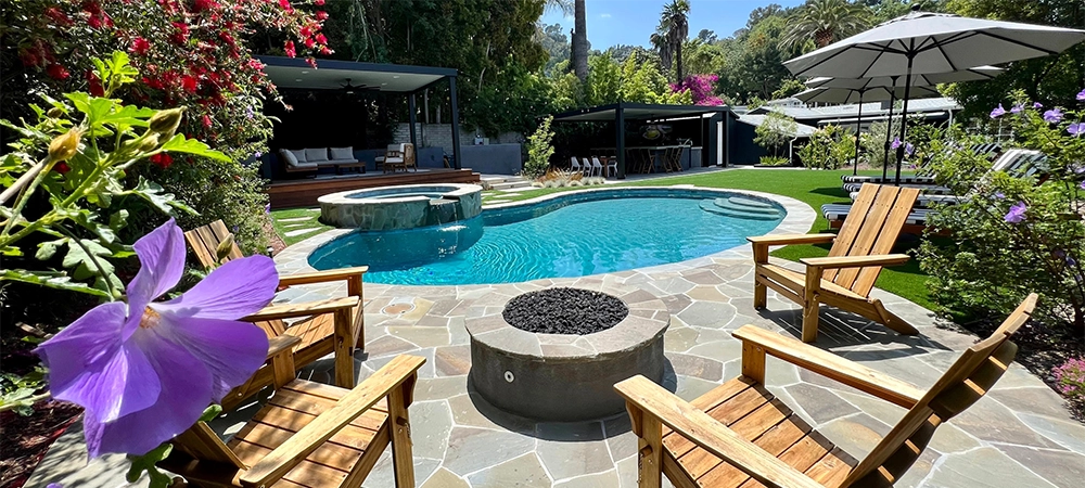 Luxurious Backyard Pool with Fire Pit and Outdoor Bar