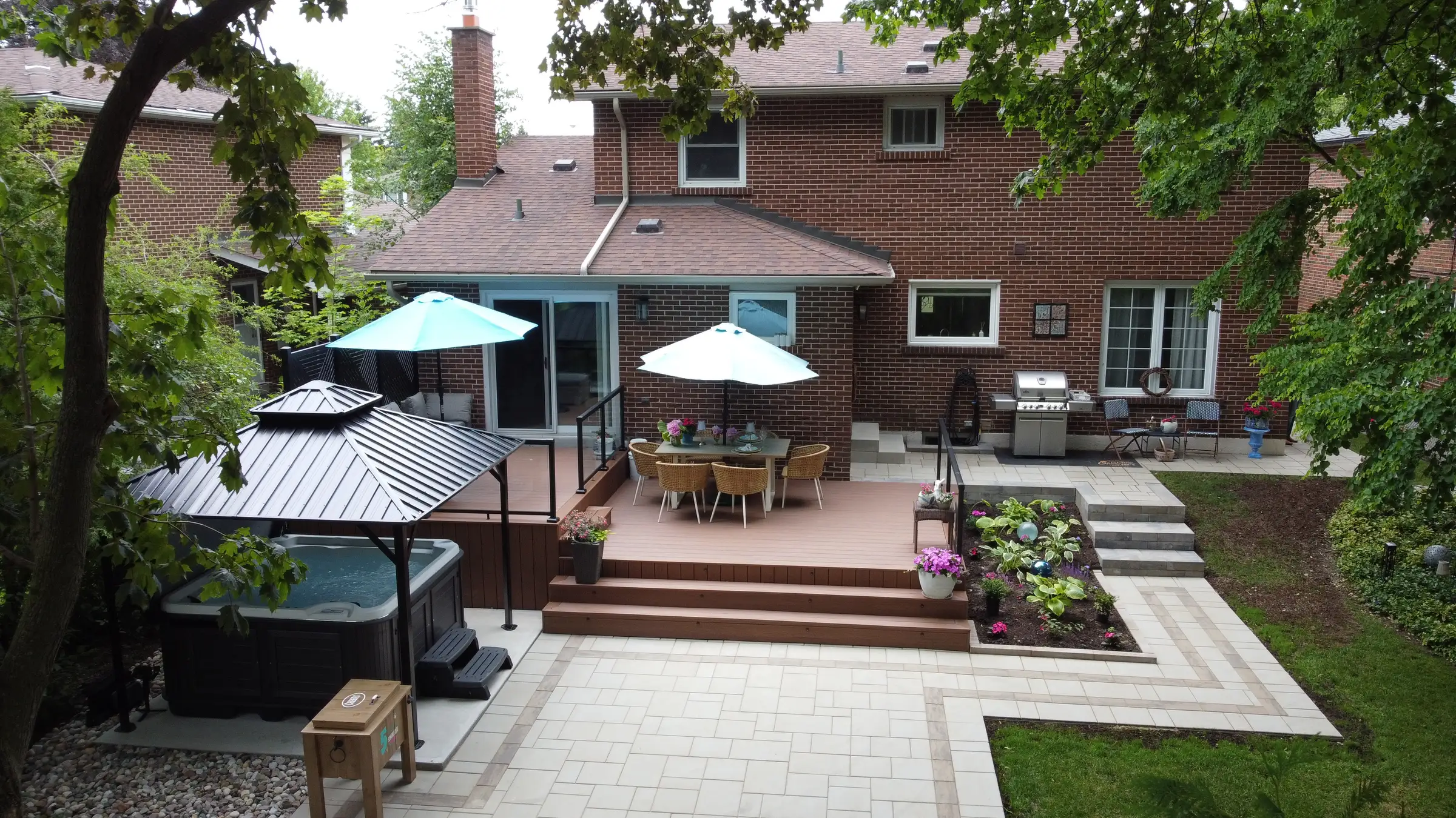 aerial backyard view of a composite deck and hot tub