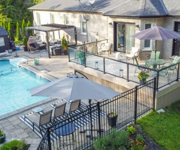 aerial-backyard-pool-deck-pergola-view large trex deck and beautiful pool interlocking