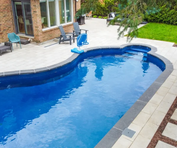 Aerial view of a backyard pool with lounge patio