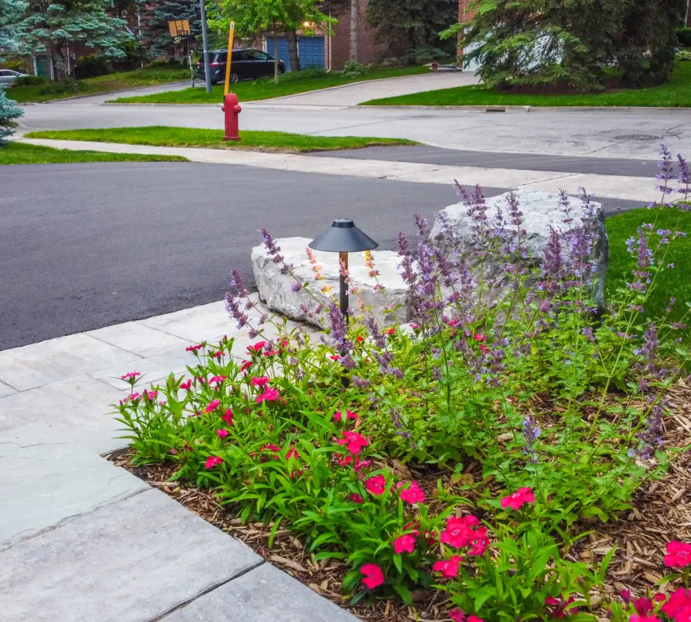 interlocked patio with flowers and a driveway