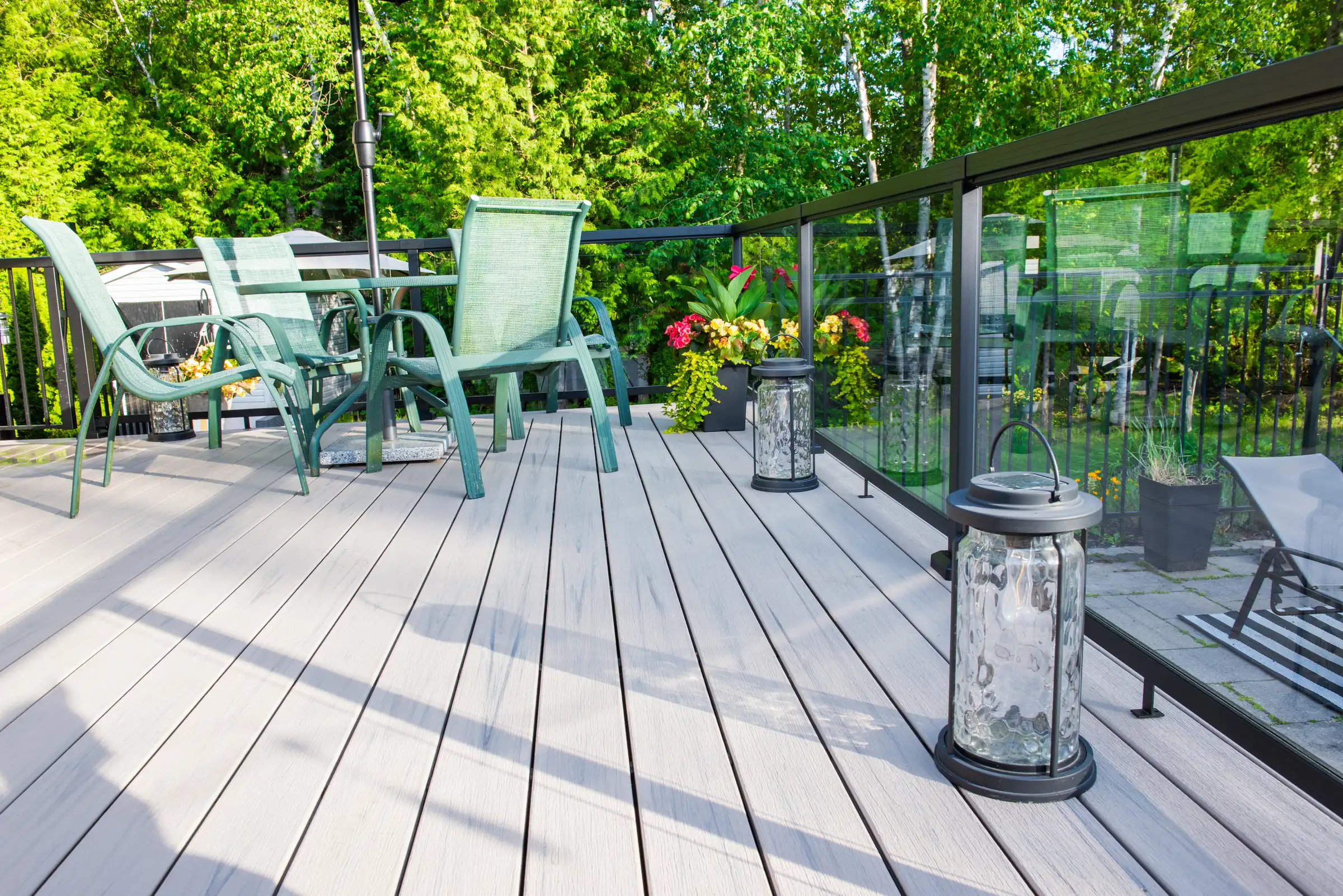 composite-deck-boards-lanterns-green-chairs composite deck boards with a lantern on it