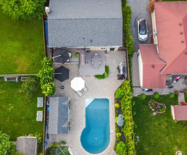 drone view of a backyard with a pool and composite deck