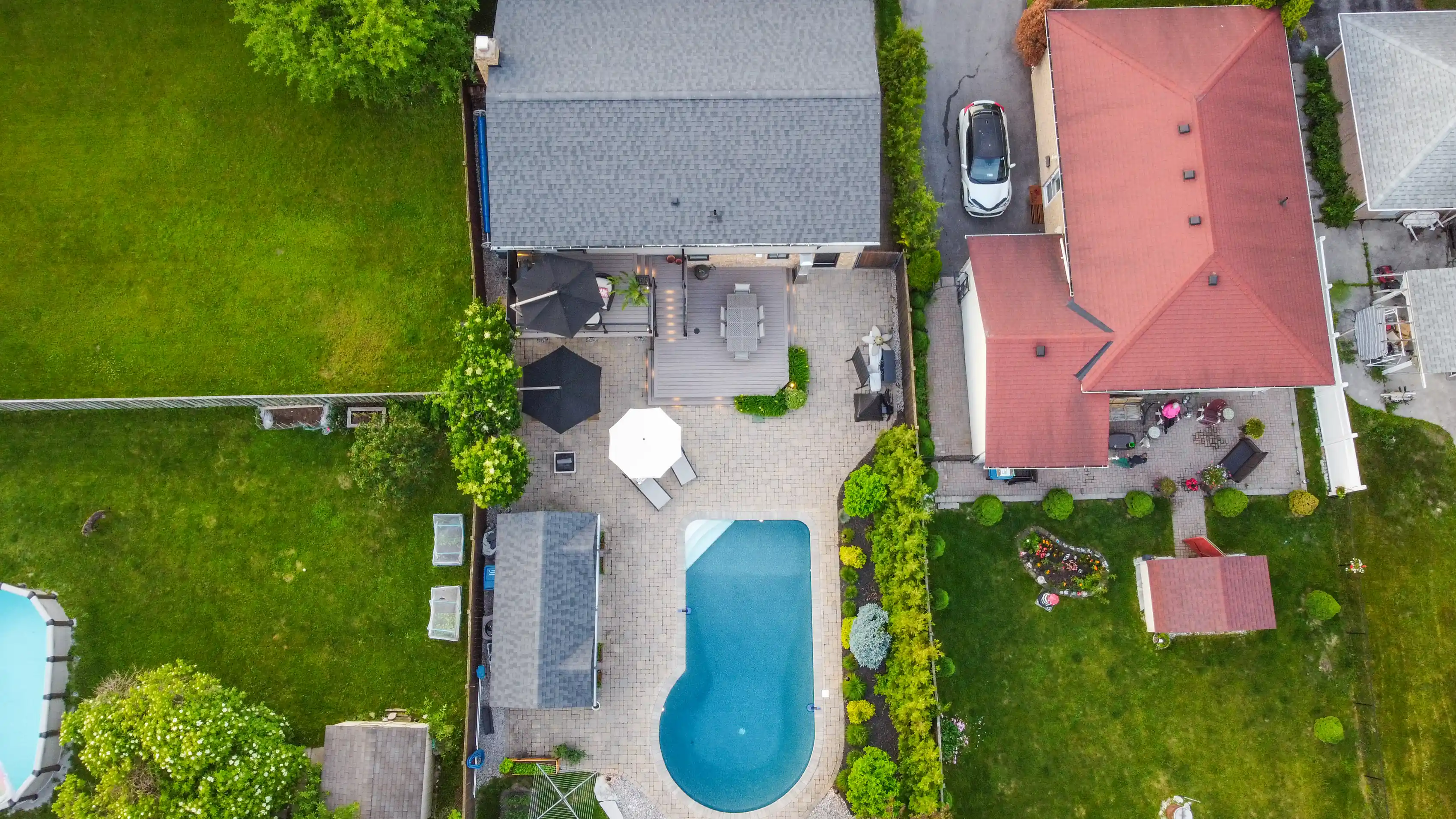 drone view of a backyard with a pool and composite deck