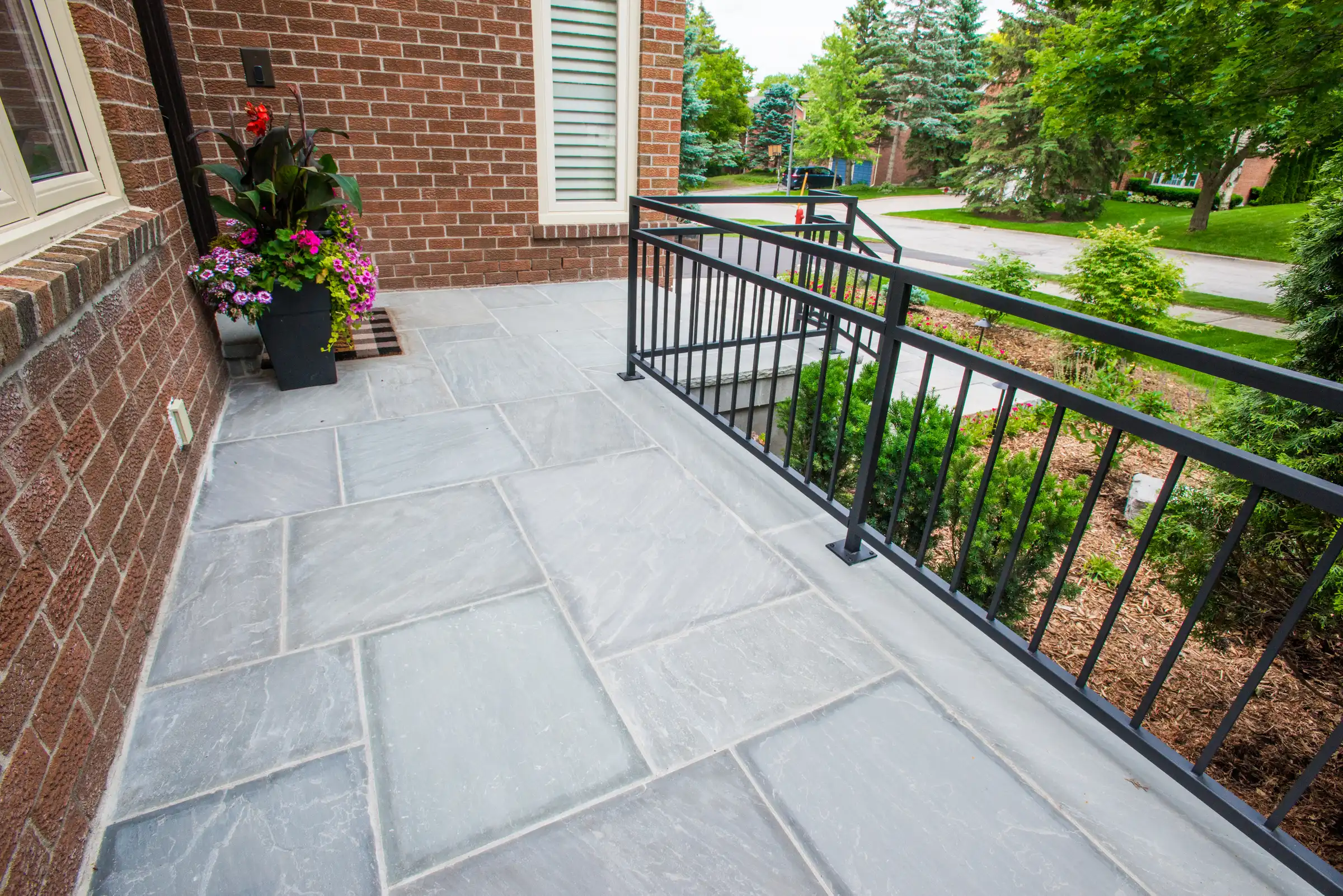paved patio with black railing