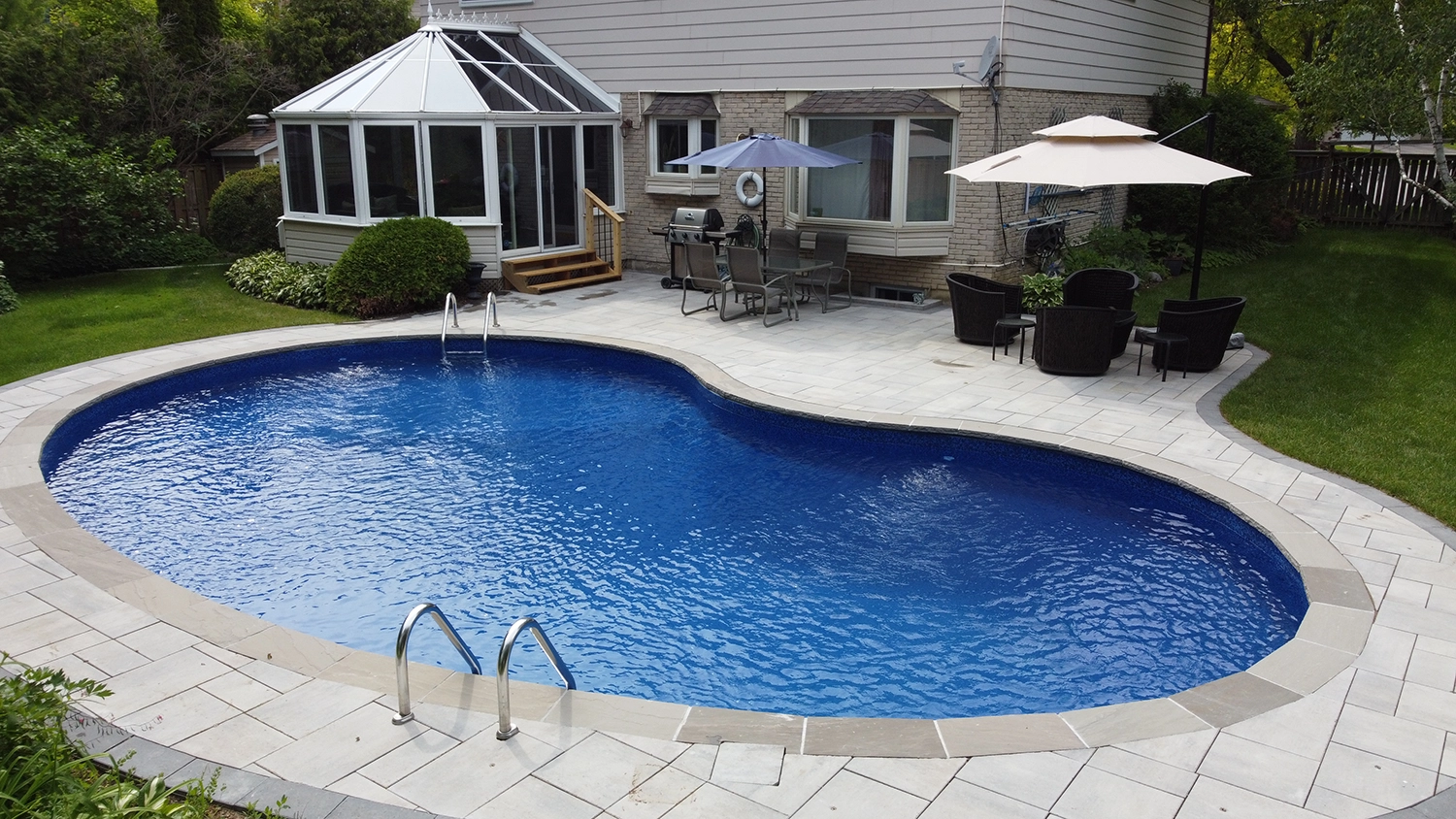 large oval pool with stairs and interlocking