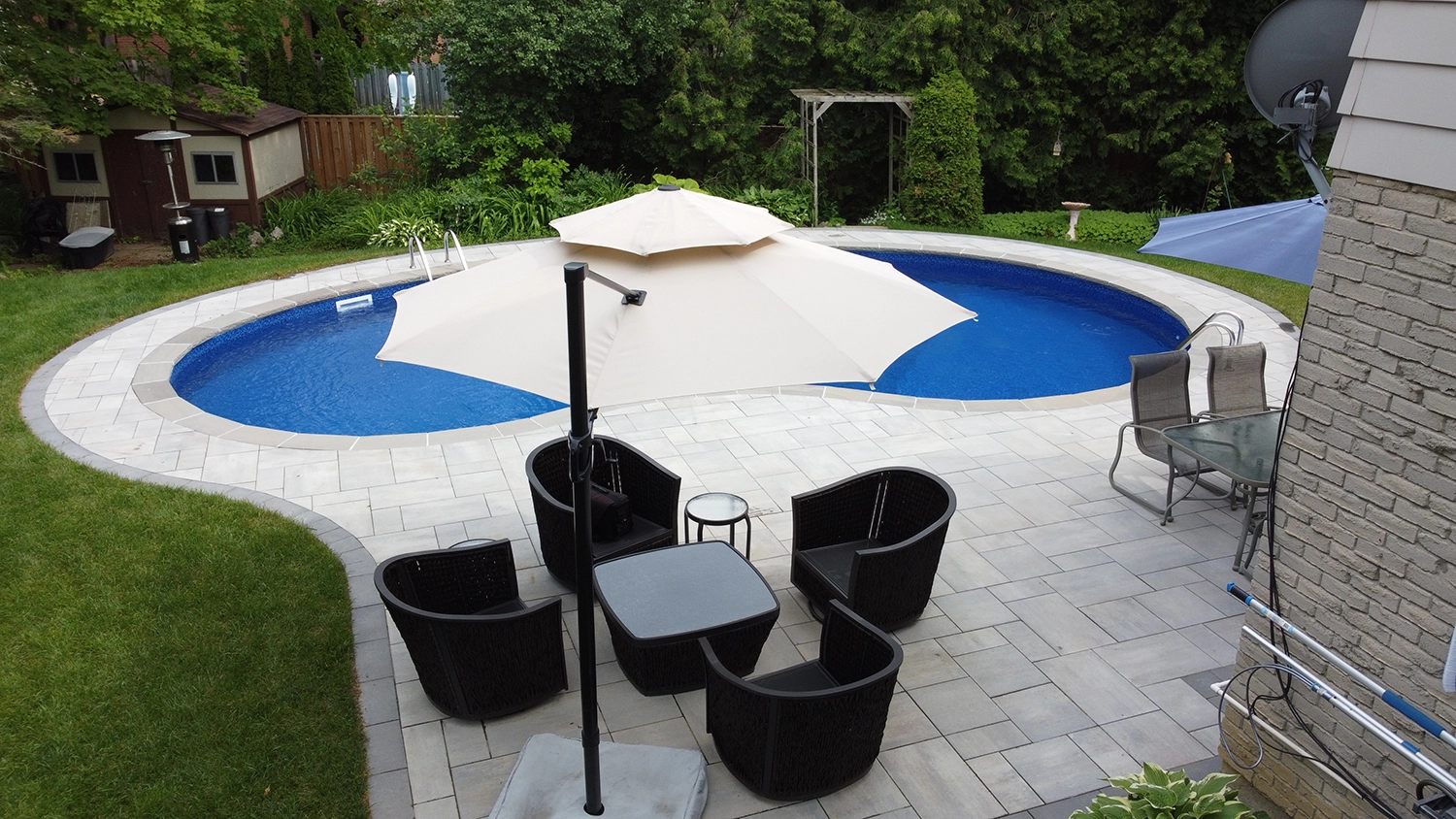 aerial shot of patio furniture with a pool and inerlocking