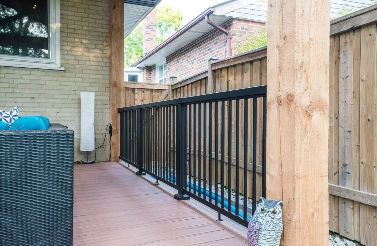 Deck railing view beside a pergola