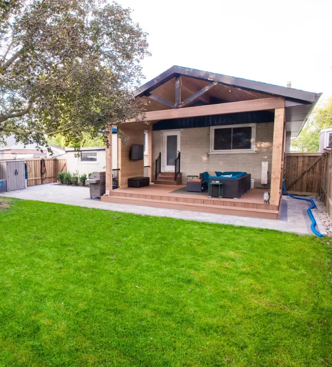 Backyard lawn with custom pergola and deck