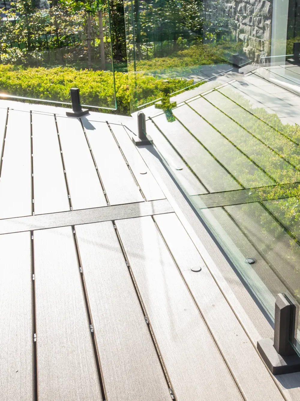 composite-deck-boards-glass-railing-angle