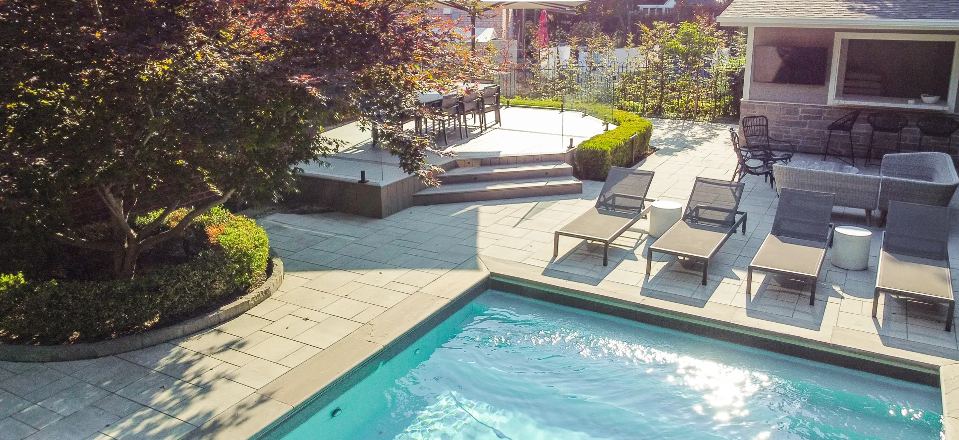 woodbridge trex deck with a pool