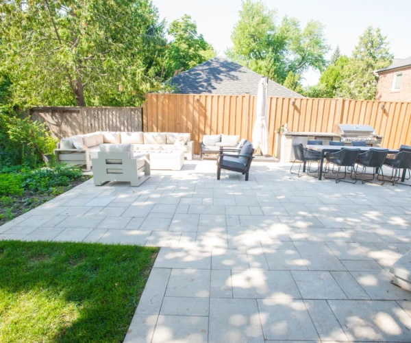 backyard-patio-outdoor-kitchen-dining-wide North York interlocking patio with lounge area and outdoor kitchen