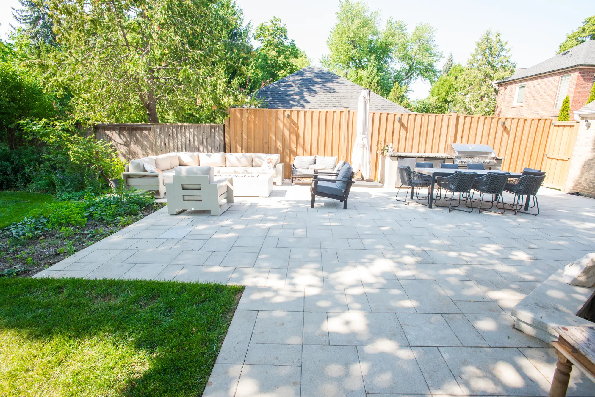 North York interlocking patio with lounge area and outdoor kitchen