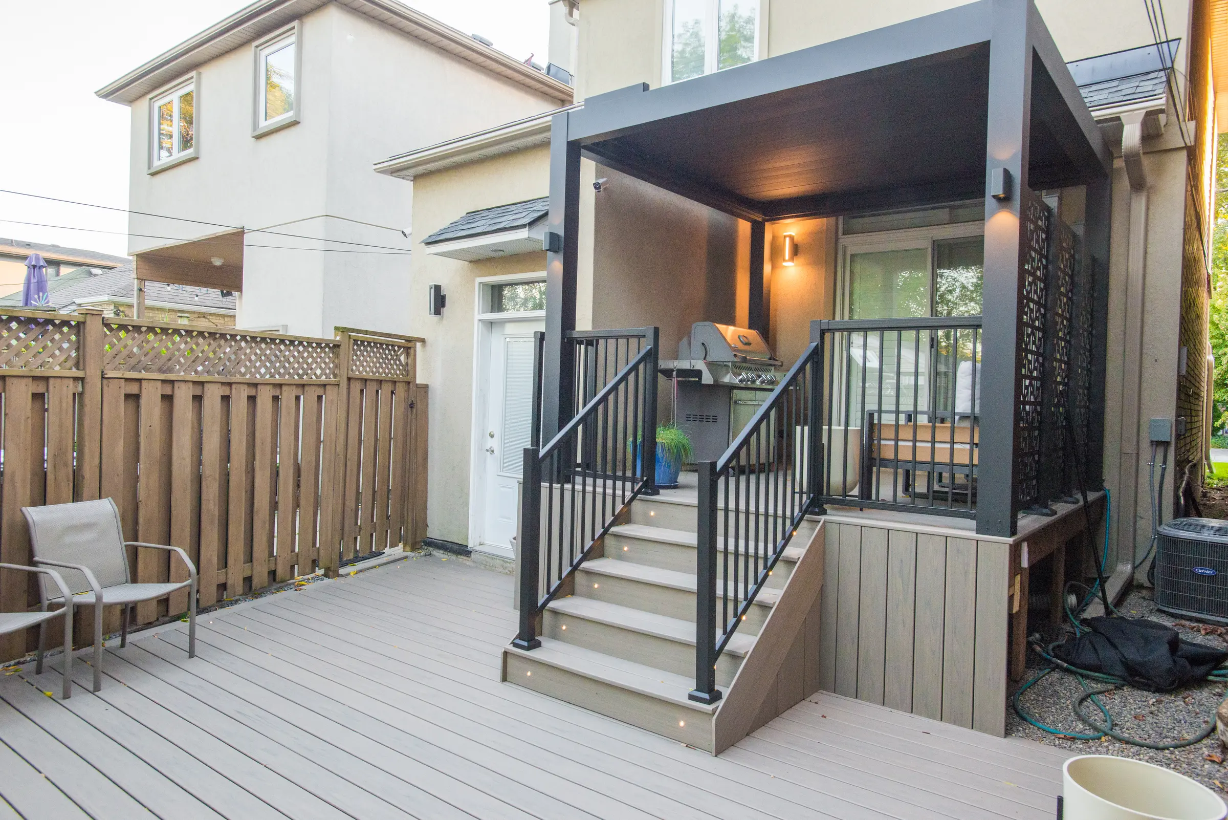 Angled view of the electric pergola and Trex deck
