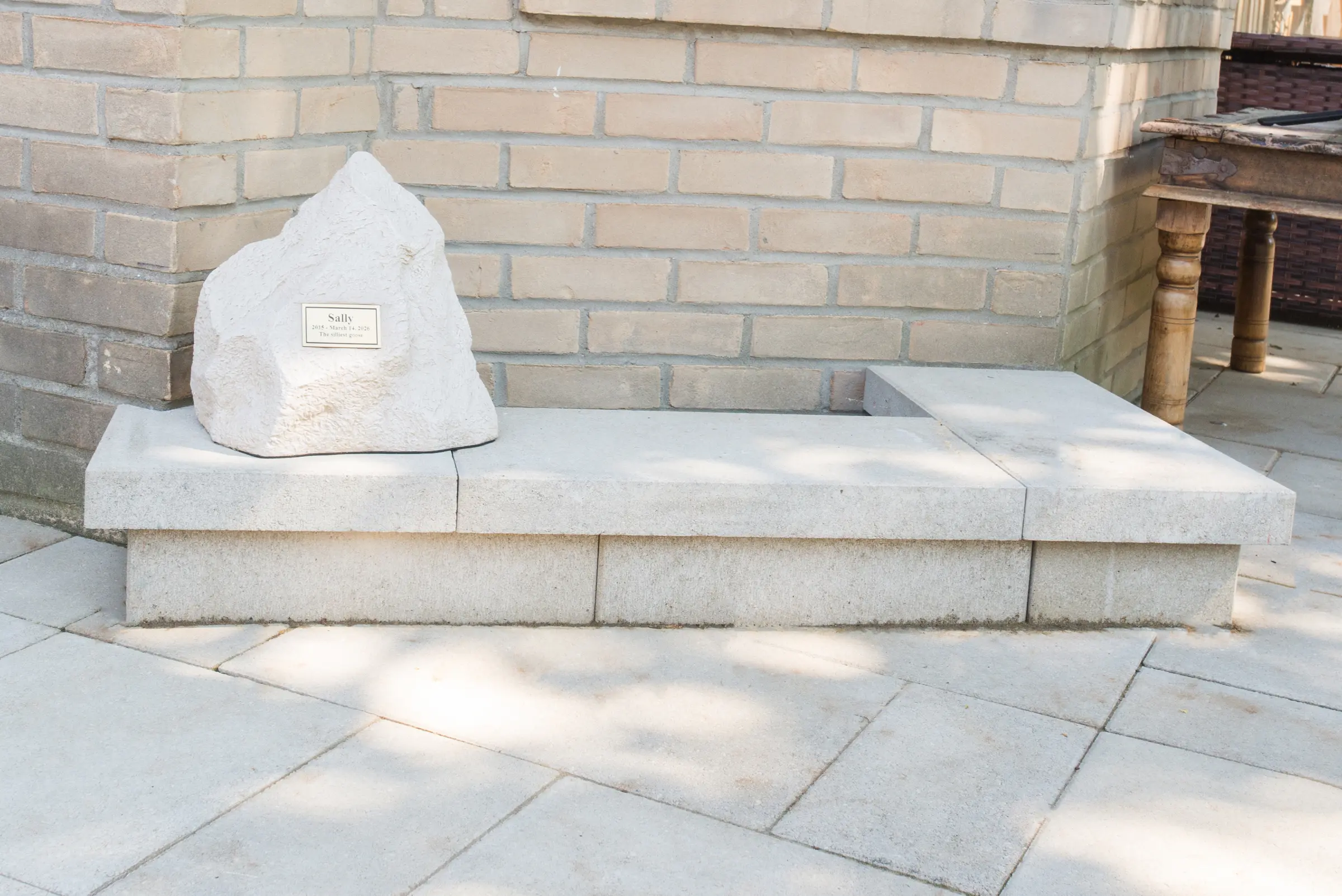 Close-up of memorial stone set on a natural stone bench