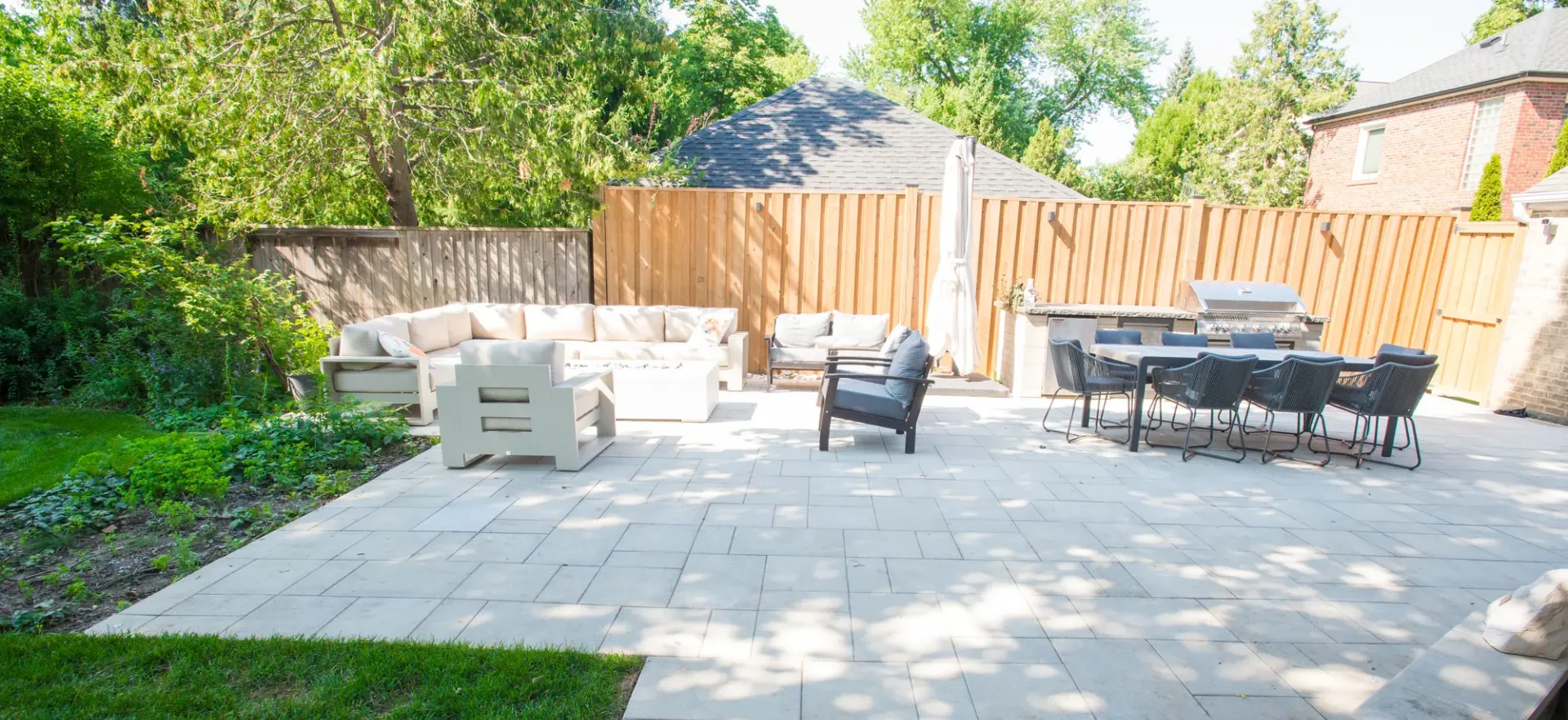 North York interlocking patio with outdoor kitchen and lounge area