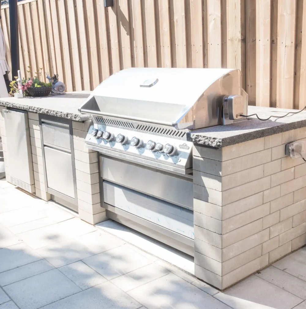 outdoor-kitchen-grill-fridge-closeup Outdoor kitchen with built-in grill and fridge on interlocking patio