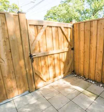 wooden-privacy-fence-gate-closeup Wooden privacy fence gate opening onto interlocking stone